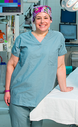 Nurse in scrubs with colorful hair cap